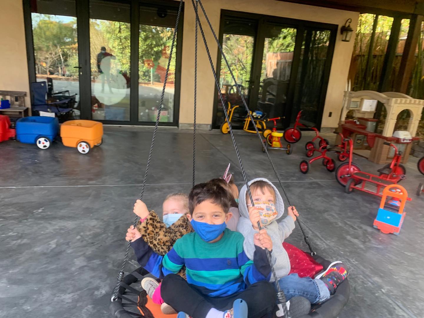 Children riding the platform swing together