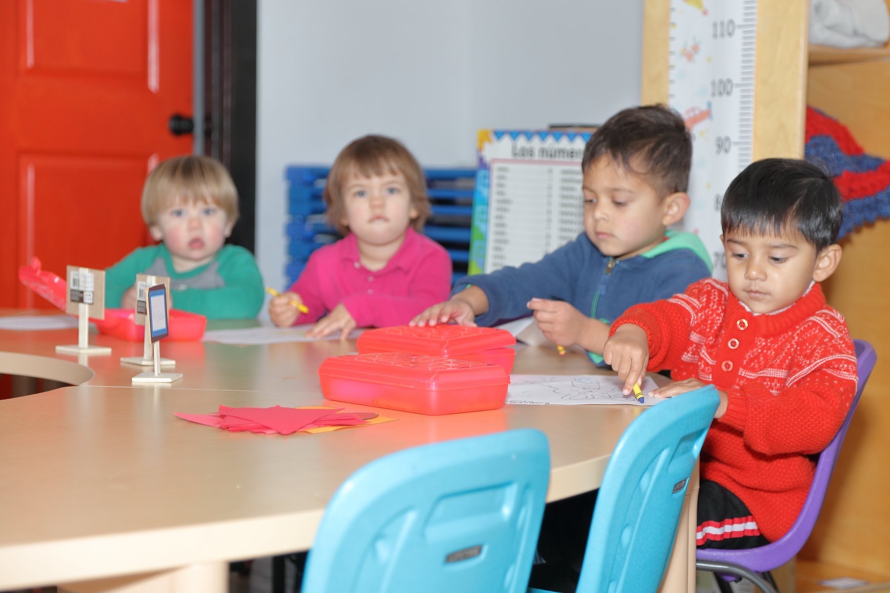 Children focused on table activities in the Spanish immersion classroom