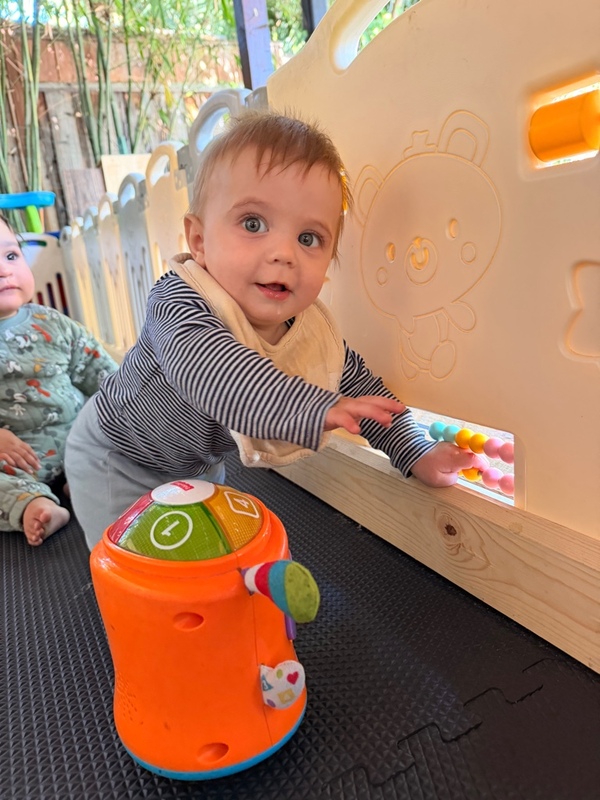 Baby exploring a colorful activity toy