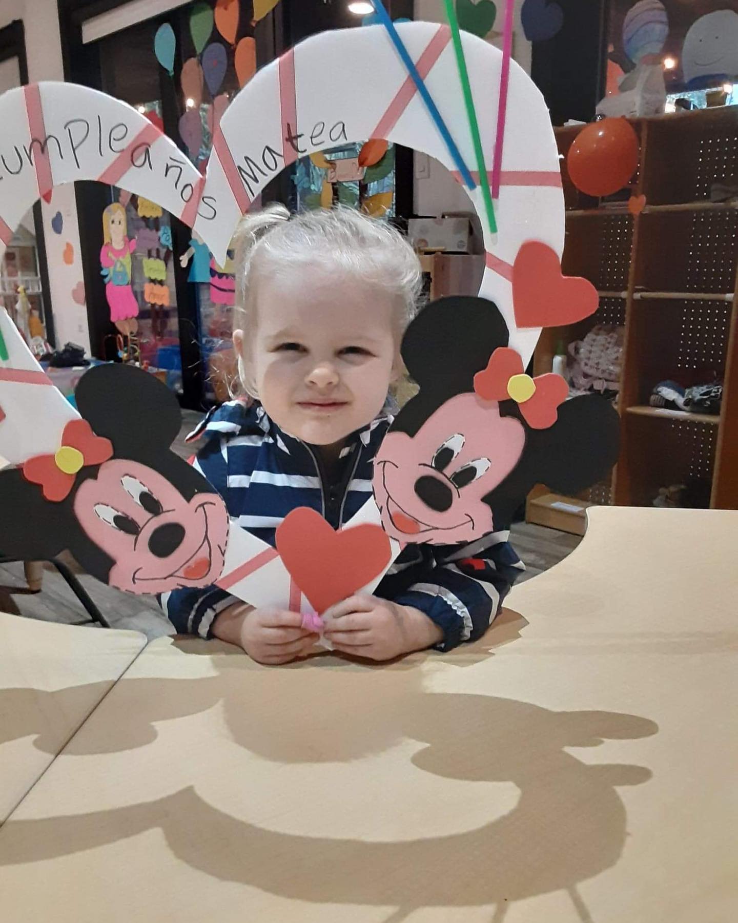 A preschooler showing off her birthday celebration craft