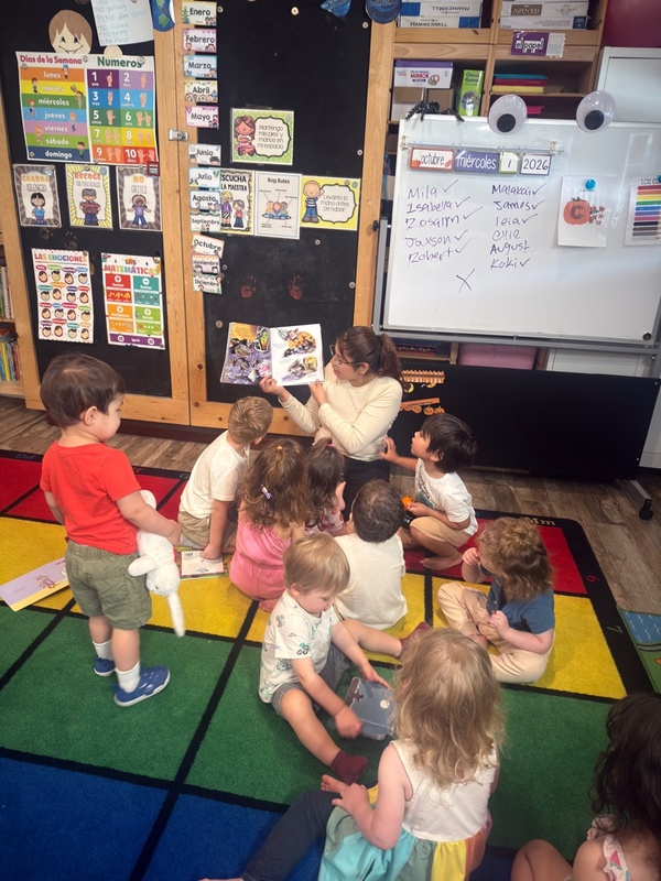 Children sharing a story with their teacher at circle time